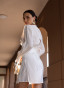 White dress with a statement belt and embroidery