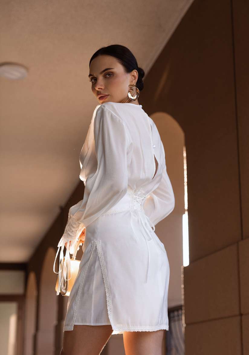 White dress with a statement belt and embroidery