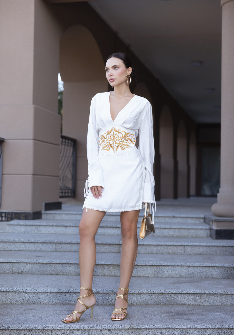 White dress with a statement belt and embroidery