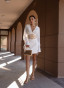 White dress with a statement belt and embroidery