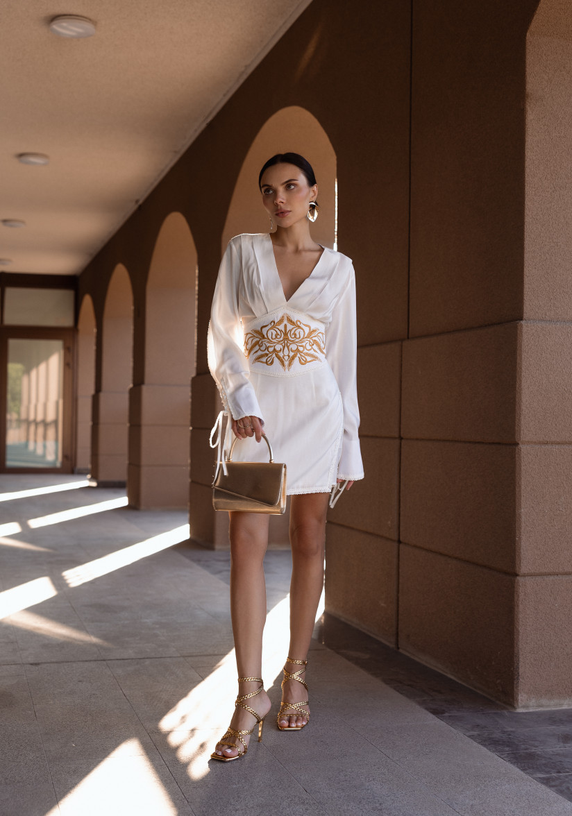 White dress with a statement belt and embroidery